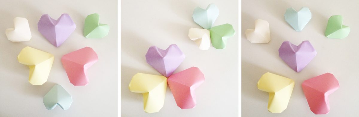 Plusieurs cœurs gonflés en papier pastel posés côte à côte