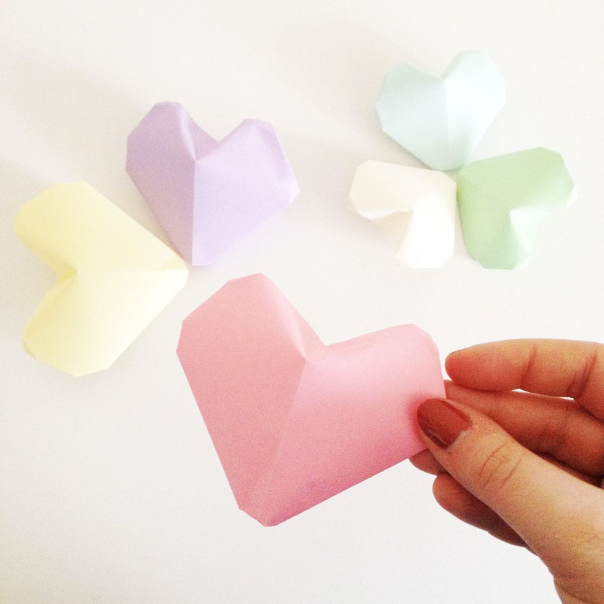 Cœur en papier gonflé en volume, tenu à la main