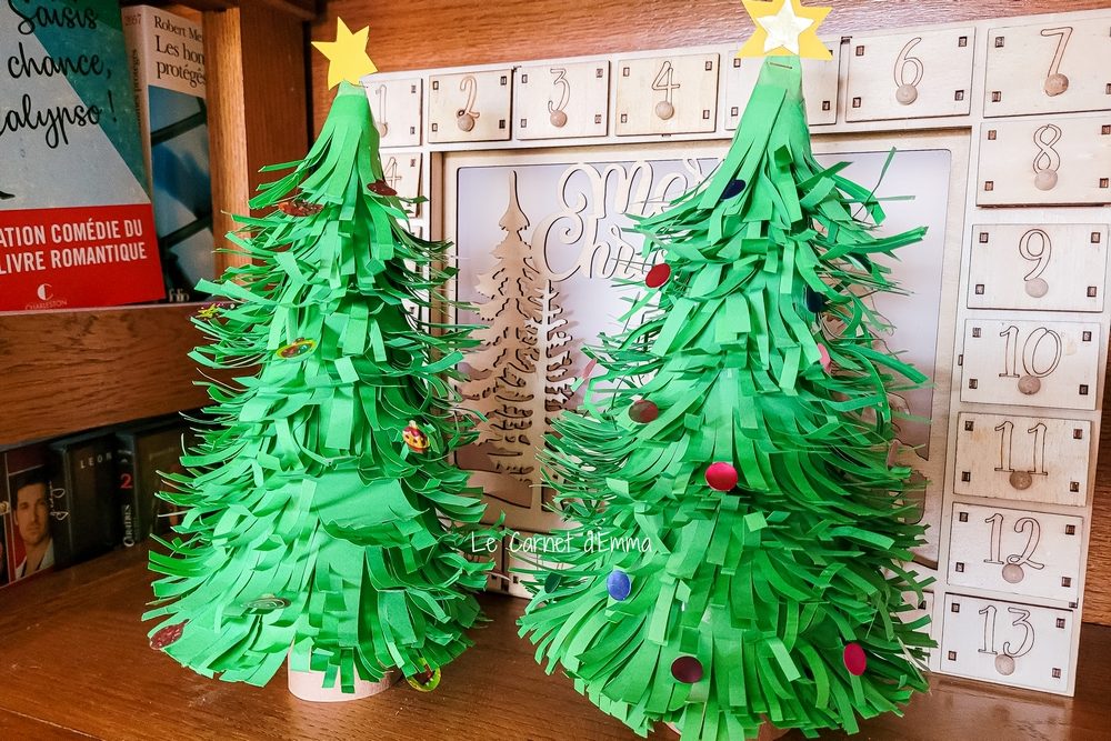 Rangée de sapins de Noël en papier 3D colorés sur une étagère
