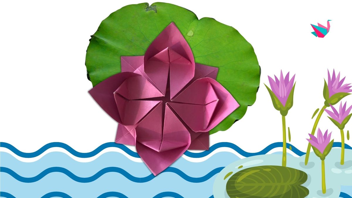 Fleur de lotus rose en papier posée sur une feuille de nénuphar