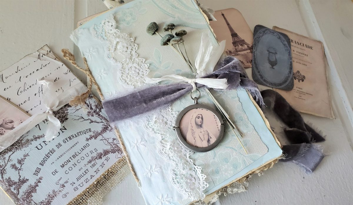 Un junk journal terminé, couverture vintage bleue et papiers anciens